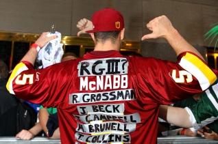 NEW YORK, NY - APRIL 26: A fan of the Washington Redskins wears a jersey with the names of some of the Redskins previous quartebacks including quarterbacl prospect Robert Griffin III from Baylor during the 2012 NFL Draft at Radio City Music Hall on April 26, 2012 in New York City. (Photo by Al Bello/Getty Images)
